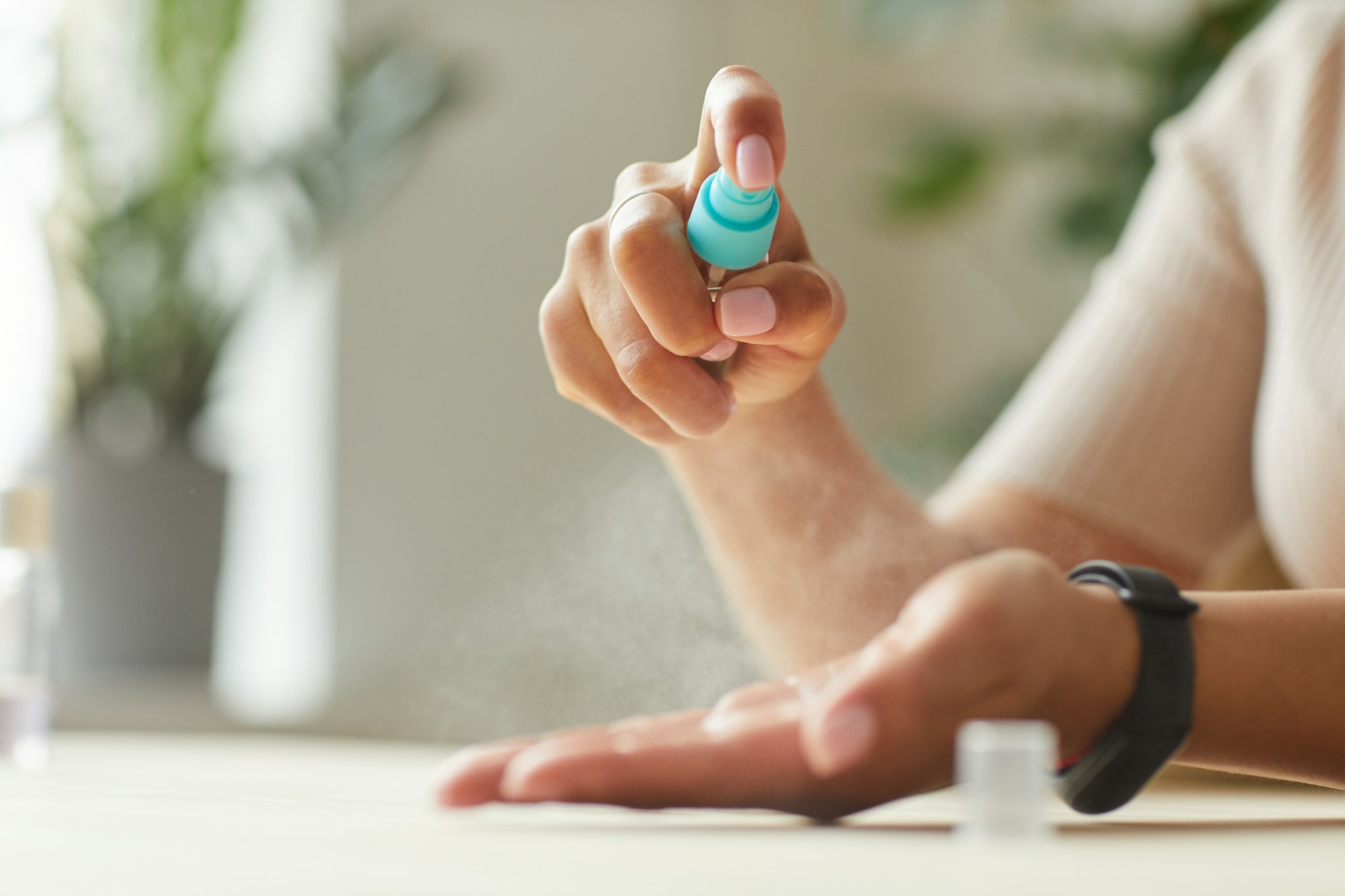 Woman Spraying Hand Sanitizer Close Up